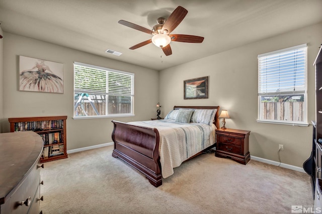 carpeted bedroom featuring baseboards and ceiling fan
