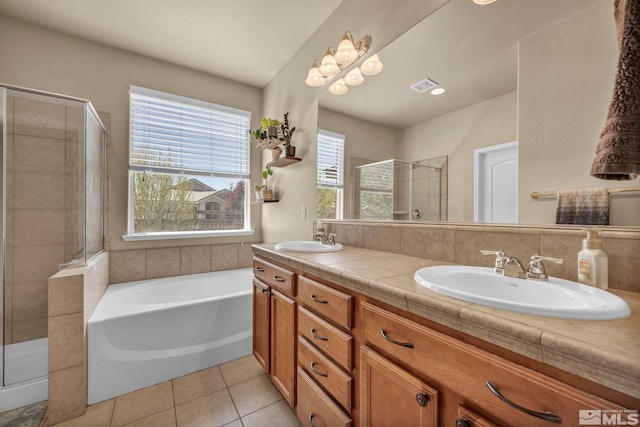 full bathroom featuring a shower stall, tile patterned floors, a garden tub, and double vanity