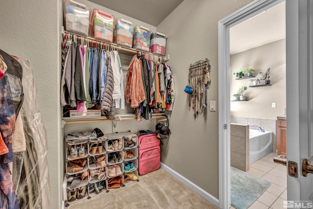 walk in closet with tile patterned floors