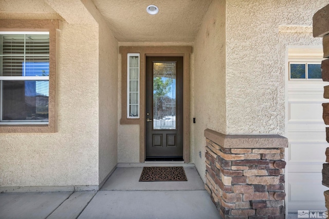 doorway to property with stucco siding