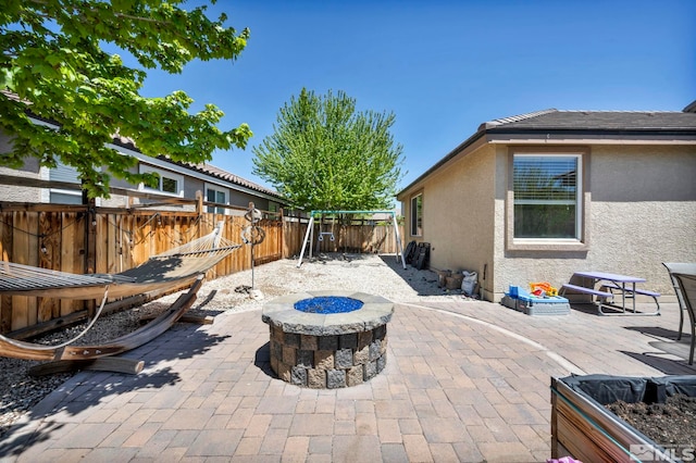 view of patio with a fire pit and a fenced backyard
