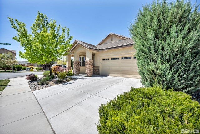 view of front of property with driveway, a garage, stone siding, and a tiled roof