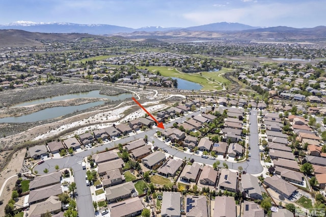 aerial view of property's location with nearby suburban area and a water and mountain view