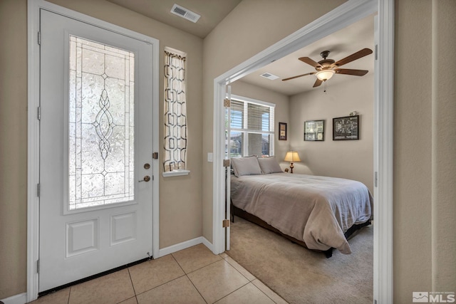 bedroom featuring light tile patterned floors, baseboards, and a ceiling fan