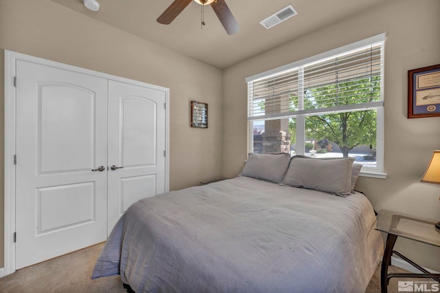 bedroom featuring multiple windows, carpet floors, a closet, and ceiling fan