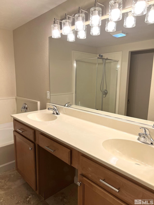 bathroom with a shower stall, a bath, double vanity, and a textured wall