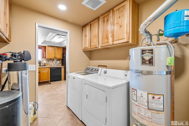 laundry area with water heater, independent washer and dryer, cabinet space, and light tile patterned flooring