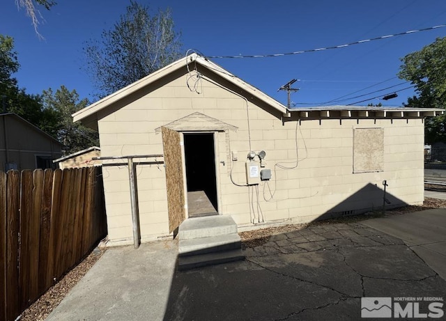 view of outbuilding with fence