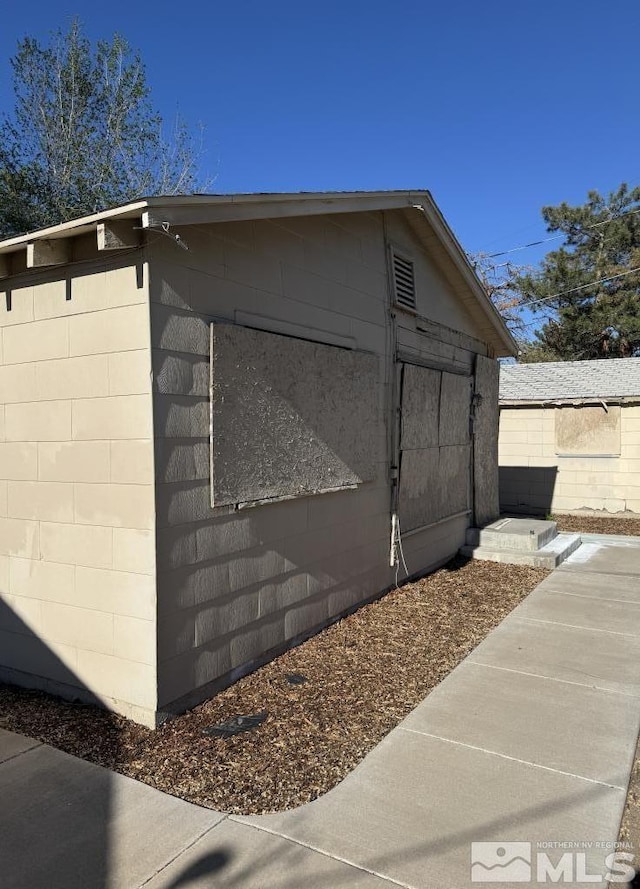 view of property exterior featuring concrete block siding