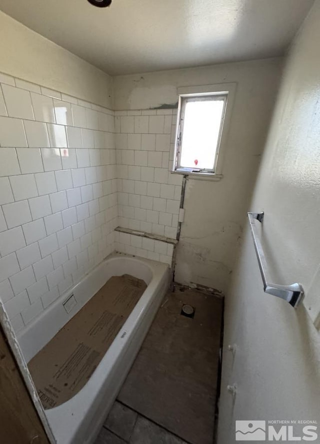 full bathroom featuring a bath and a shower