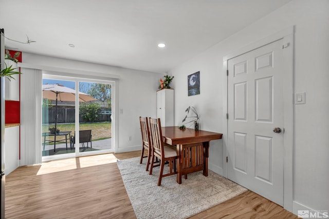 dining area featuring light wood-type flooring, recessed lighting, and baseboards