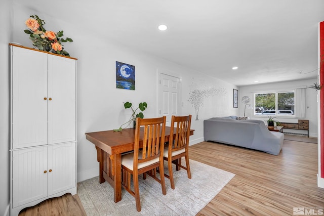 dining space with light wood-type flooring, baseboards, and recessed lighting