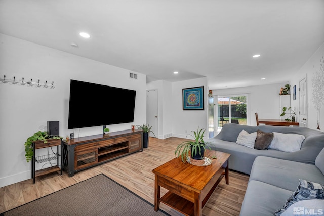 living room featuring wood finished floors, recessed lighting, and baseboards