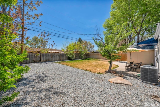 view of yard with central air condition unit and a patio