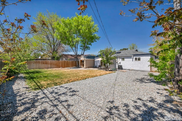 back of house with a patio, a storage unit, an outdoor structure, and central AC unit