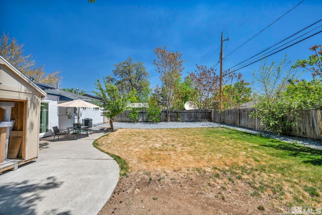 view of yard with central AC and a patio area