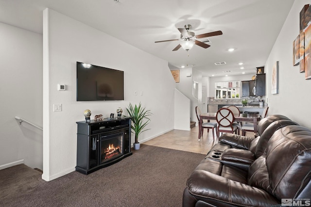 living room featuring ceiling fan, dark carpet, recessed lighting, and baseboards