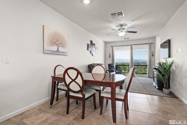 dining space featuring baseboards and ceiling fan