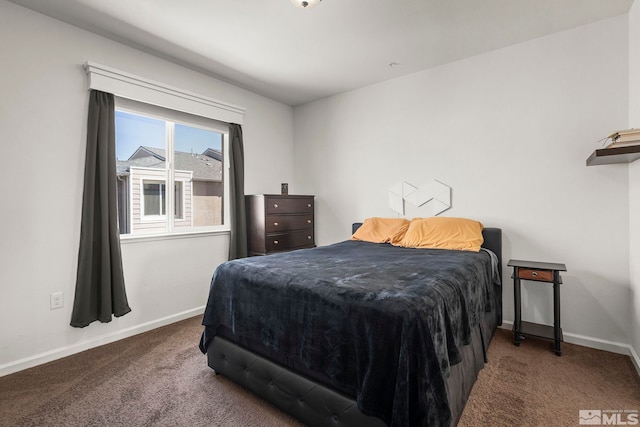 bedroom featuring carpet and baseboards