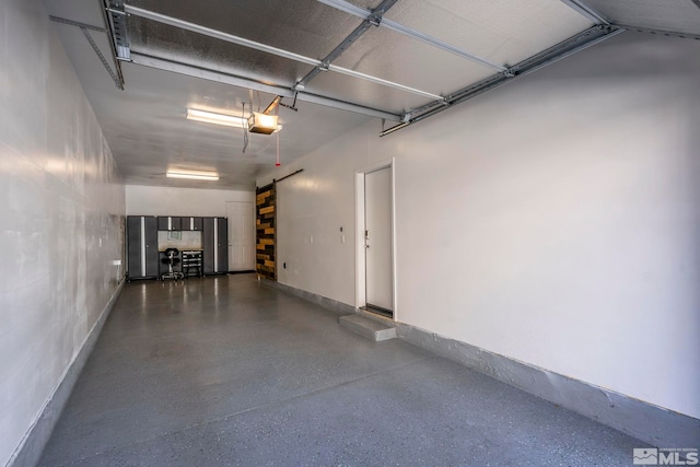 garage featuring a garage door opener and baseboards