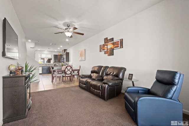 carpeted living room featuring ceiling fan, recessed lighting, and tile patterned floors
