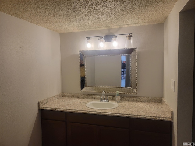 bathroom featuring a textured ceiling and vanity