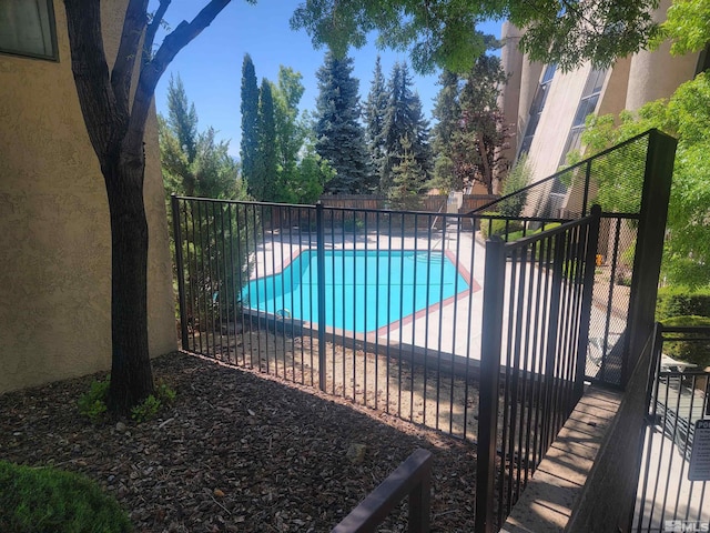 view of swimming pool featuring a fenced backyard and a patio