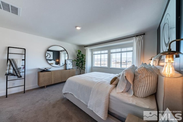 carpeted bedroom featuring baseboards