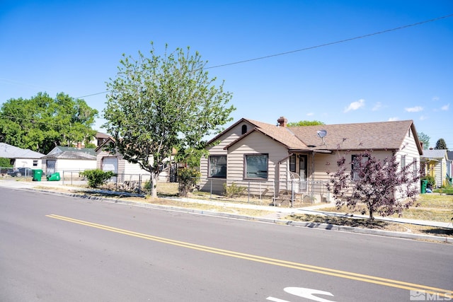 view of front facade featuring a fenced front yard and a chimney