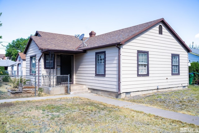 view of front of house with a chimney and roof with shingles