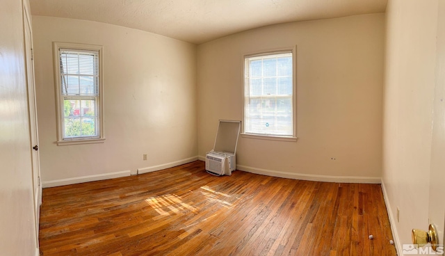 unfurnished room featuring hardwood / wood-style flooring and baseboards