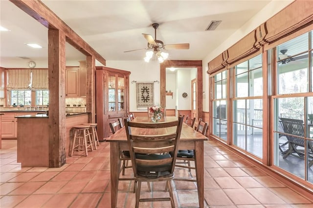 dining area with light tile floors and ceiling fan