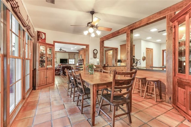 dining area with ceiling fan and light tile floors