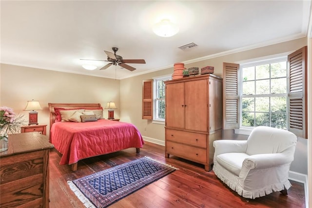 bedroom featuring ceiling fan, crown molding, and dark wood-type flooring