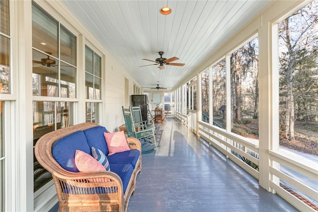 sunroom / solarium with wood ceiling and ceiling fan