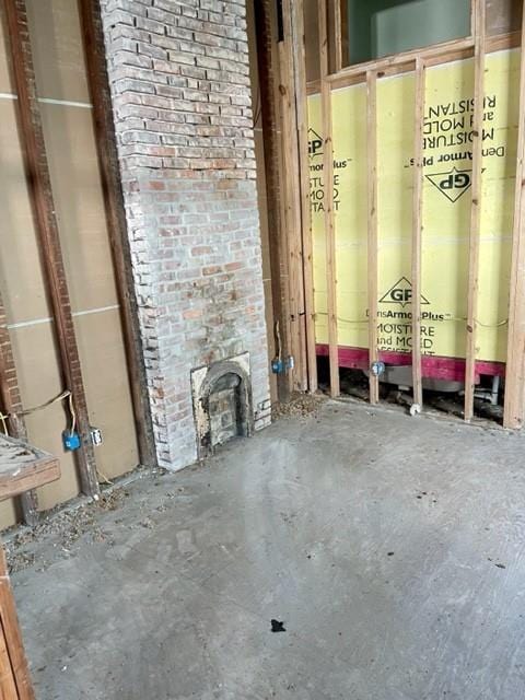 interior space with brick wall and concrete flooring