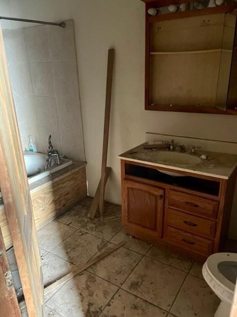 bathroom featuring toilet, tile floors, and vanity