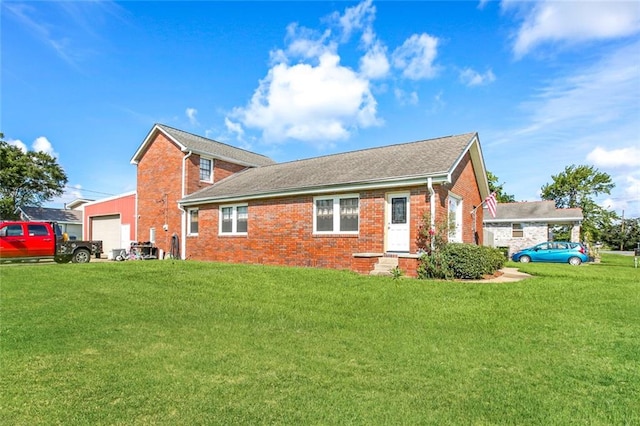 back of house with a lawn and a garage