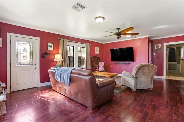 living room featuring crown molding, dark wood-type flooring, ceiling fan, and a wealth of natural light