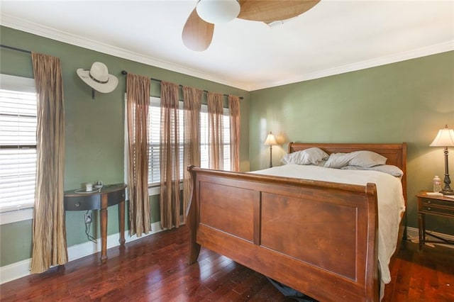 bedroom with ornamental molding, ceiling fan, and dark hardwood / wood-style flooring