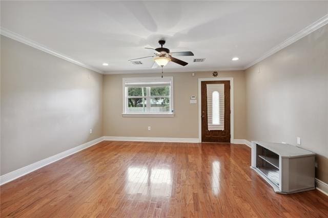 foyer with ceiling fan, light wood-type flooring, and ornamental molding