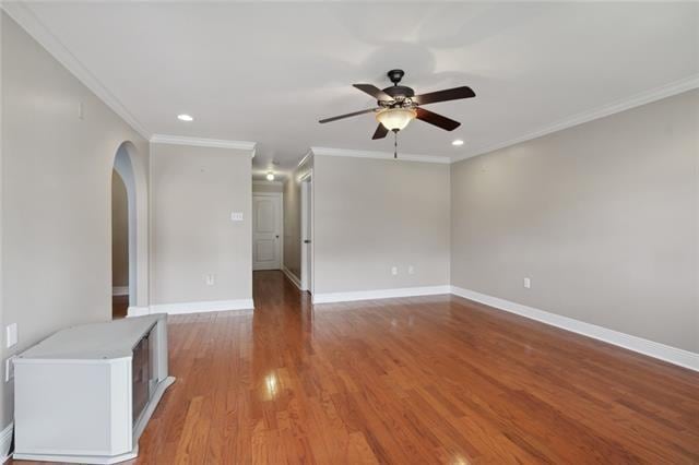 unfurnished room featuring ceiling fan, crown molding, and dark hardwood / wood-style floors