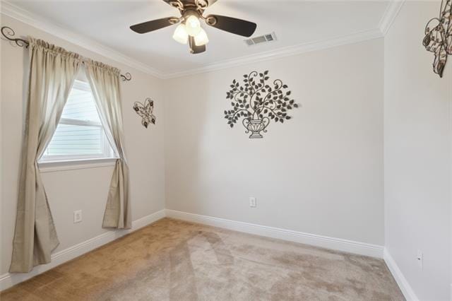 empty room with light colored carpet, ceiling fan, and crown molding