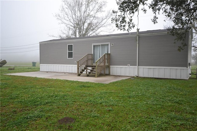 back of house featuring a yard and a patio area