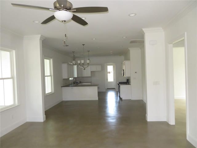 kitchen with plenty of natural light, range, white cabinetry, and ceiling fan with notable chandelier