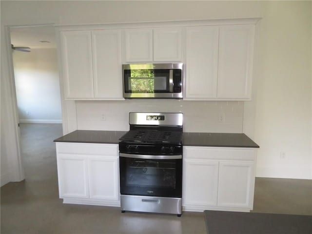 kitchen with white cabinets, appliances with stainless steel finishes, and backsplash