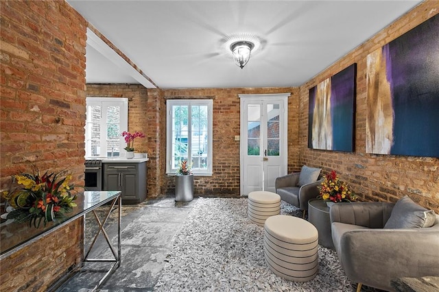 interior space with dark tile flooring and brick wall