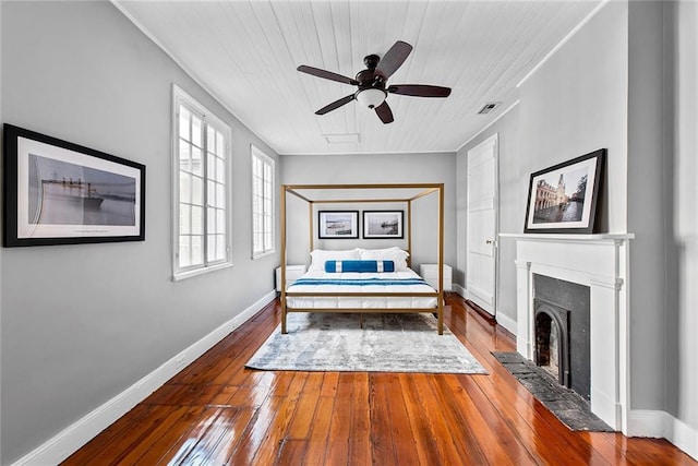 unfurnished bedroom with ceiling fan, multiple windows, and dark wood-type flooring