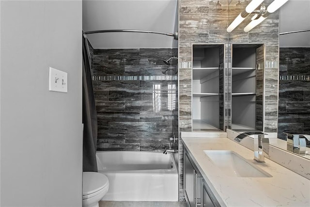 full bathroom featuring toilet, vanity, tiled shower / bath, tile walls, and tile flooring