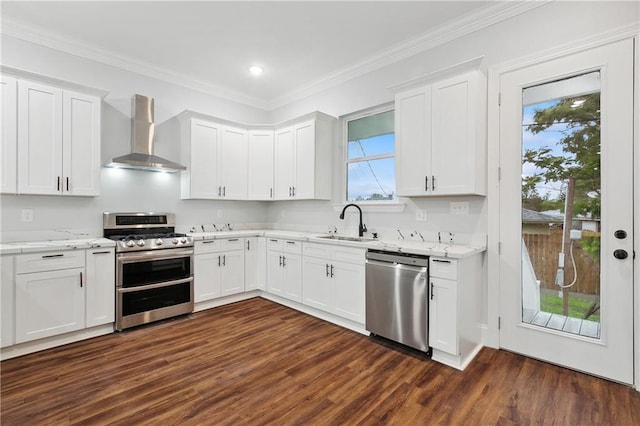 kitchen featuring dark hardwood / wood-style floors, a wealth of natural light, stainless steel appliances, and wall chimney exhaust hood